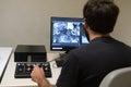 Young man scientist working with scanning electron microscope