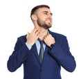 Young man scratching neck on white background.