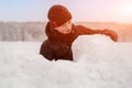 young man sculpts from snow. The concept of active recreation and leisure for teenagers. Royalty Free Stock Photo