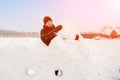 young man sculpts from snow. The concept of active recreation and leisure for teenagers. Royalty Free Stock Photo