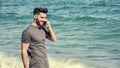 Young man by the sea talking on mobile phone Royalty Free Stock Photo