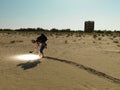 Young man searching through sand with light Royalty Free Stock Photo