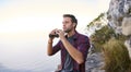 Young man searching for sights with his binoculars outdoors Royalty Free Stock Photo