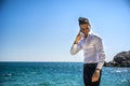 Young man at the seaside talking on cell phone Royalty Free Stock Photo