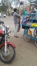 Young man selling domestic plastic products on hand cart