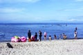 Young man sells and peddles ring lifebuoy on white sand beach