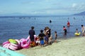 Young man sells and peddles ring lifebuoy on white sand beach