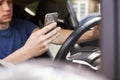 Young Man Sending Text Message Whilst Driving Royalty Free Stock Photo