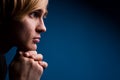 Young man with a serious look over blue Royalty Free Stock Photo