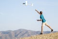 Young man setting remote control plane in air