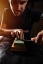 Young man sharpening the knife Royalty Free Stock Photo