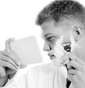 Young man shaving Royalty Free Stock Photo