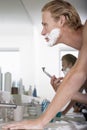 Young Man Shaving In Bathroom Royalty Free Stock Photo