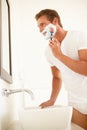 Young Man Shaving In Bathroom Mirror Royalty Free Stock Photo