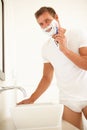 Young Man Shaving In Bathroom Mirror Royalty Free Stock Photo