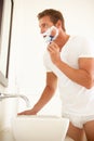 Young Man Shaving In Bathroom Mirror Royalty Free Stock Photo