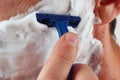 Young man shaving his face closeup Royalty Free Stock Photo