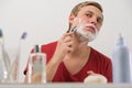 Young man shaving