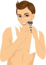 Young man shaving with razor