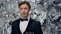 Young Man On Shiny Background With Glasses Of Champagne. Party. He Raises His Glass And Smiles. Royalty Free Stock Photo