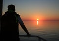 Young man on a ship during a cruise enjoys the sunrise Royalty Free Stock Photo