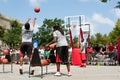 Young Man Shoots Three Pointers In Outdoor Street Basketball Tournament