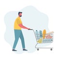 Young man with shopping cart full of food and drinks Royalty Free Stock Photo