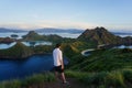 Young man enjoys beautiful view over Padar island in Komodo, Indonesia Royalty Free Stock Photo