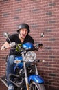 Young man shouting as he speeds on his motorbike Royalty Free Stock Photo