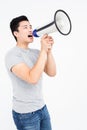 Young man shouting on horn loudspeaker Royalty Free Stock Photo