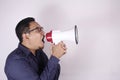 Young Man Shouting with Megaphone, Angry Expression