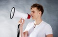 Young man shouting in megaphone.