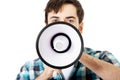 Young man shouting through megaphone. Royalty Free Stock Photo