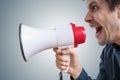 Young man is shouting to megaphone and announcing news