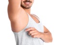 Young man showing armpit on white background closeup. Using deodorant