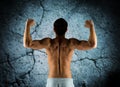 Young man showing biceps and muscles Royalty Free Stock Photo