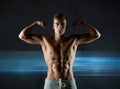 Young man showing biceps and muscles Royalty Free Stock Photo