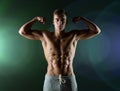 Young man showing biceps and muscles Royalty Free Stock Photo