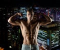 Young man showing biceps and muscles Royalty Free Stock Photo