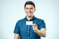 Young man showing blank business card or sign Royalty Free Stock Photo