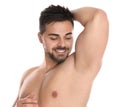 Young man showing hairless armpit after epilation on white background Royalty Free Stock Photo