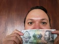 young man showing and holding honduran banknote of five lempiras Royalty Free Stock Photo