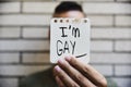 Young man showing a note with the text I am gay Royalty Free Stock Photo