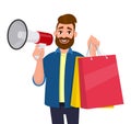 Young man showing shopping bags. Person holding a megaphone or loudspeaker in hand. Modern lifestyle, digital technology. Royalty Free Stock Photo