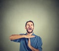 Young man showing time out hand gesture, frustrated screaming to stop Royalty Free Stock Photo