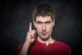 Young man shows finger up. Royalty Free Stock Photo