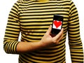 Young man shows heart on mobile phone.