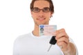 Young man shows his drivers license and car keys Royalty Free Stock Photo