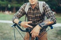 Young Man Shows A Sign Of Peace Or Victory Sitting On A Bicycle On Green Summer Meadow Royalty Free Stock Photo