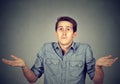 Young man shrugging shoulders who cares so what I don't know Royalty Free Stock Photo